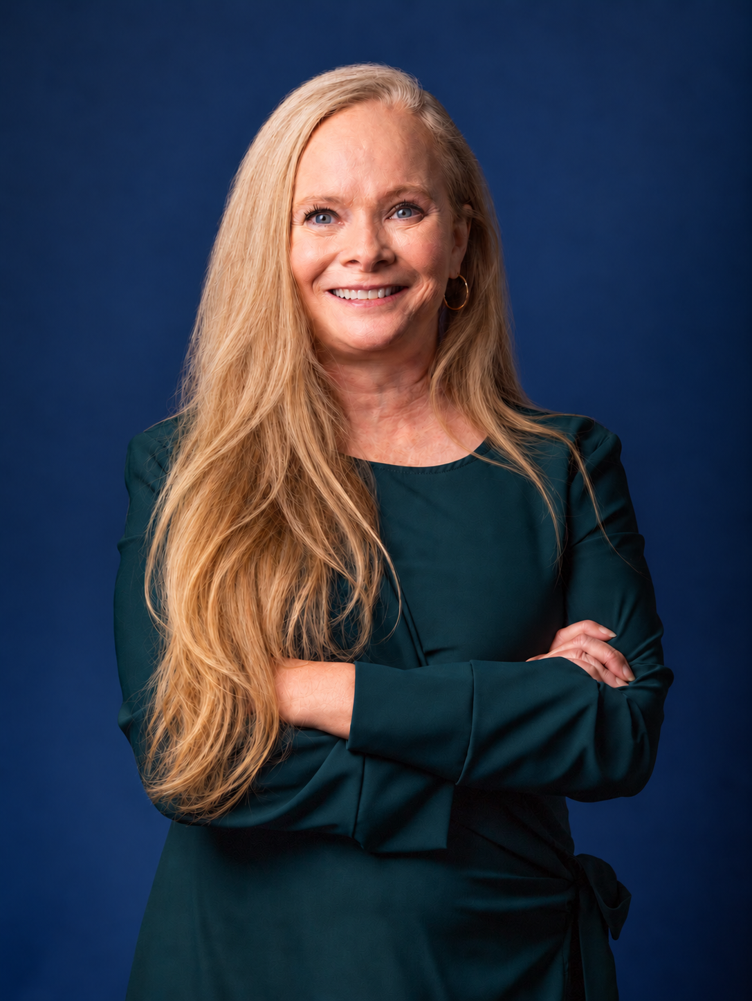 Gwen Voelpel smiling against a navy background
